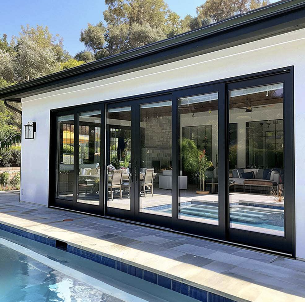 Black Rhino aluminum stacking sliding door system with pool house and indoor-outdoor living